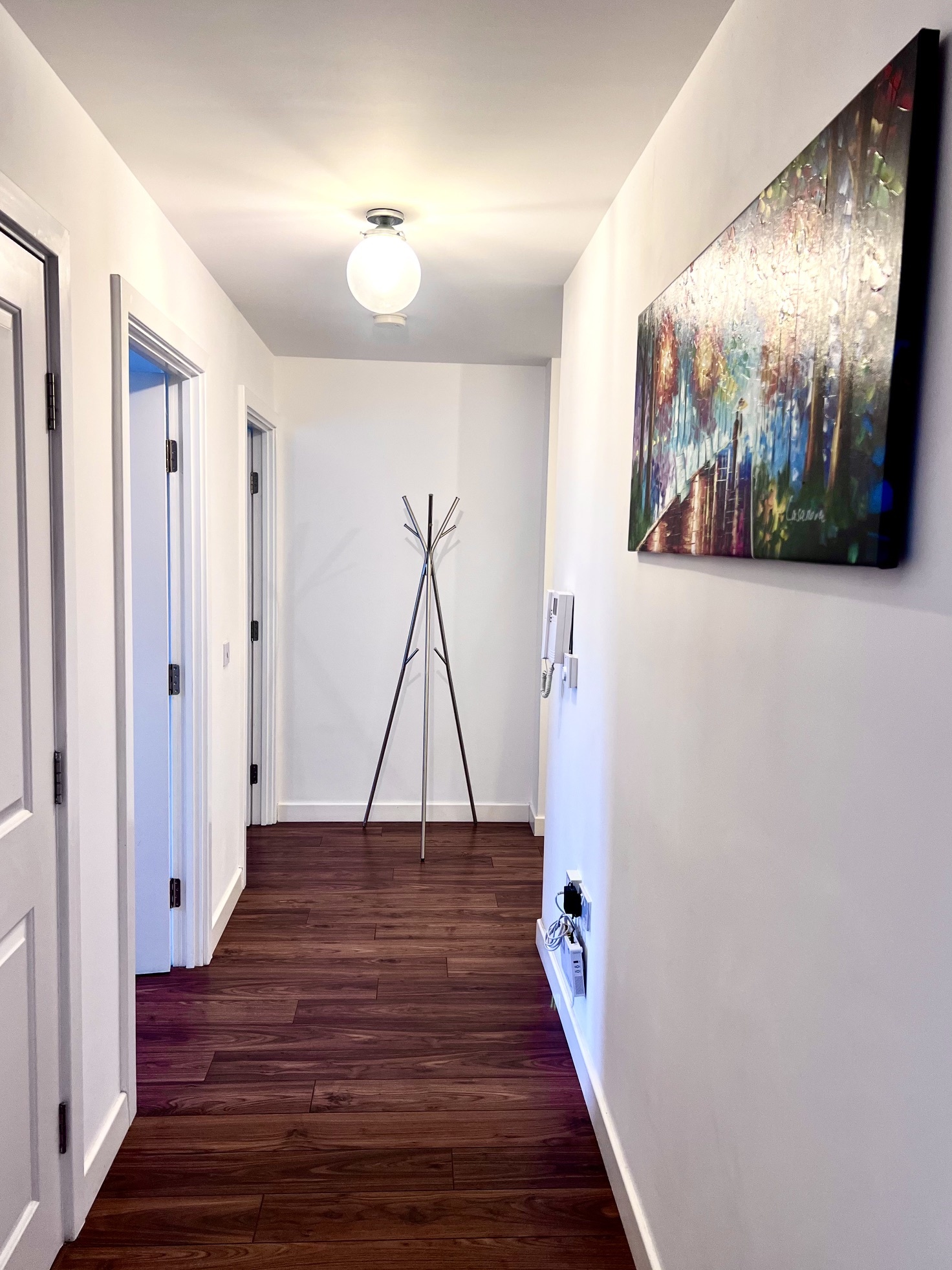 Hallway with artwork and entry intercom
